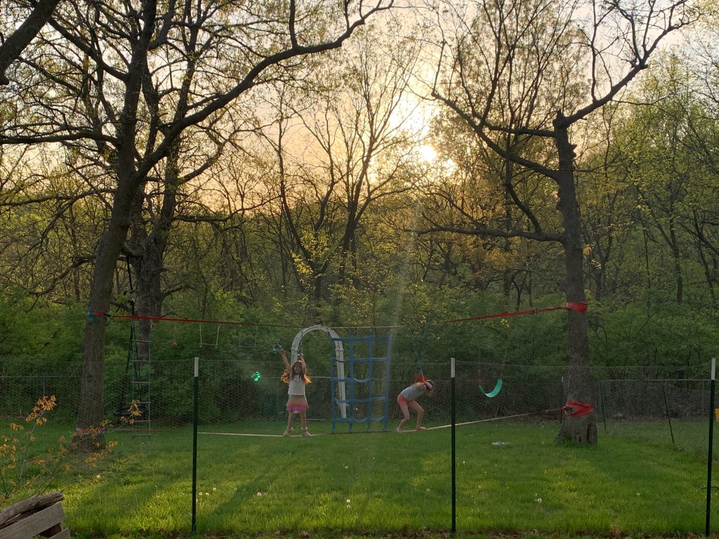 Beautiful backyard sunset with children playing